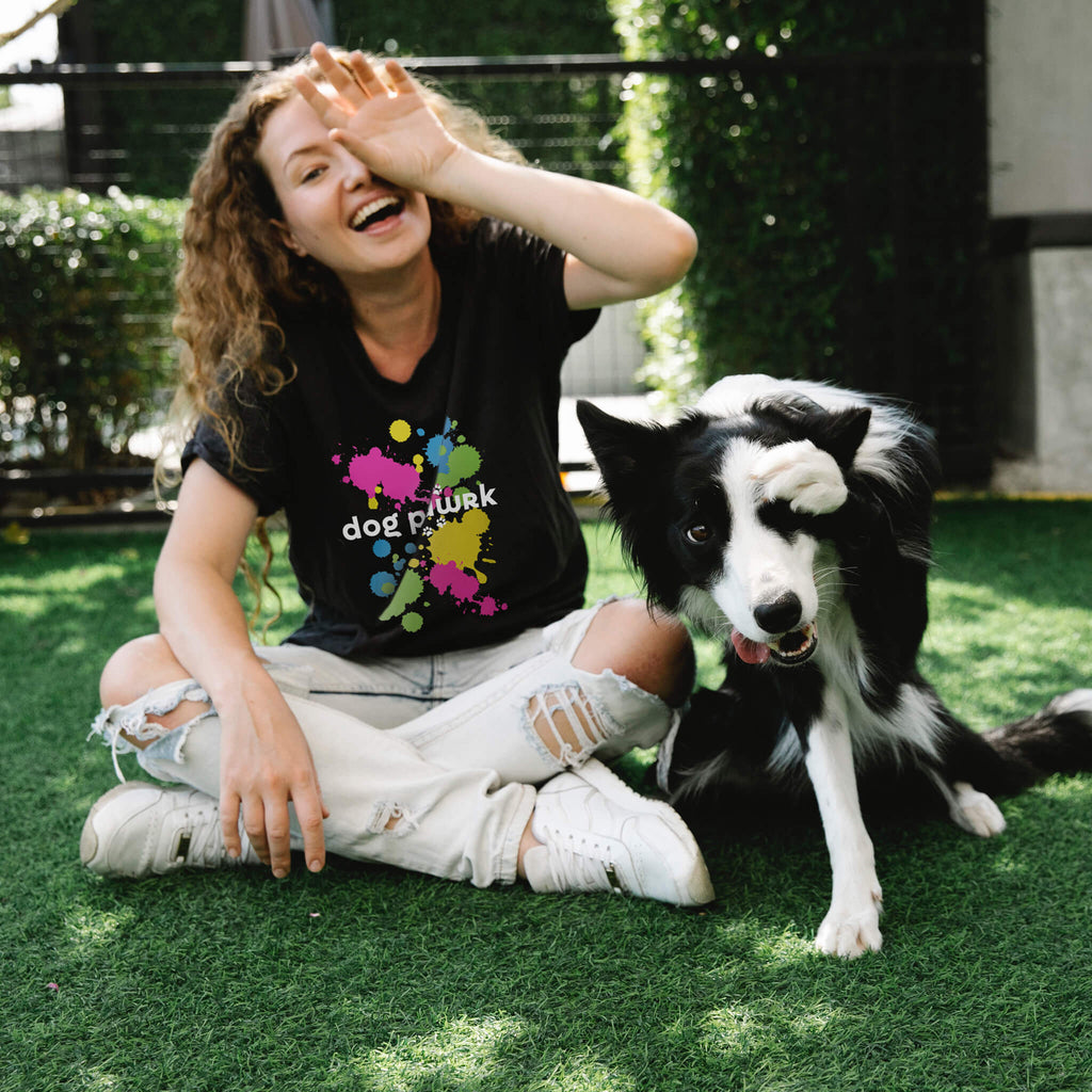 Woman wearing black Dog Pawrk t-shirt with color splatters
